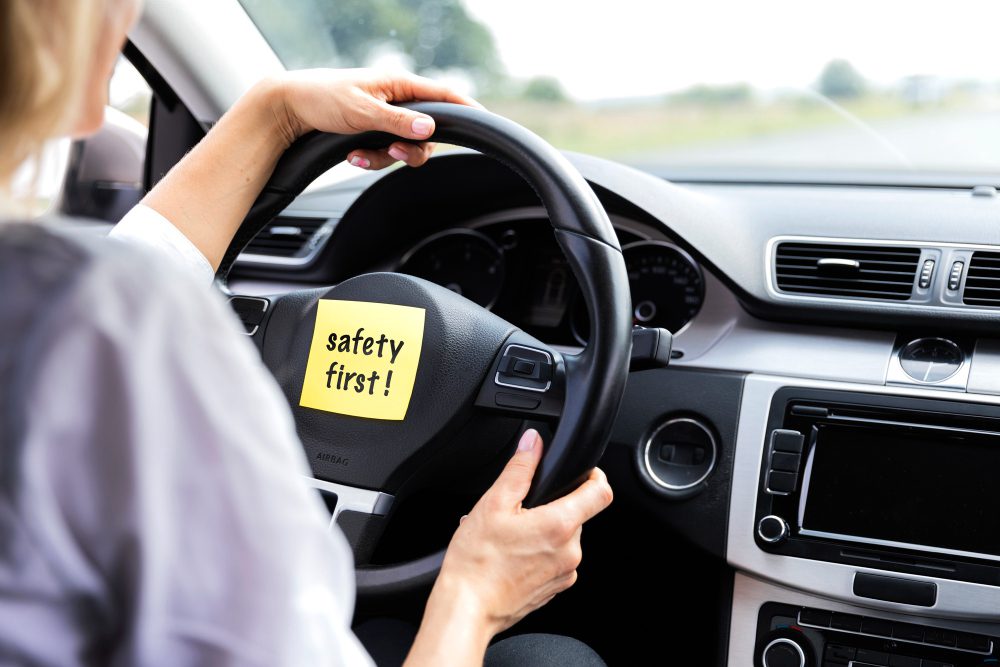 Safety first sign on the car steering.